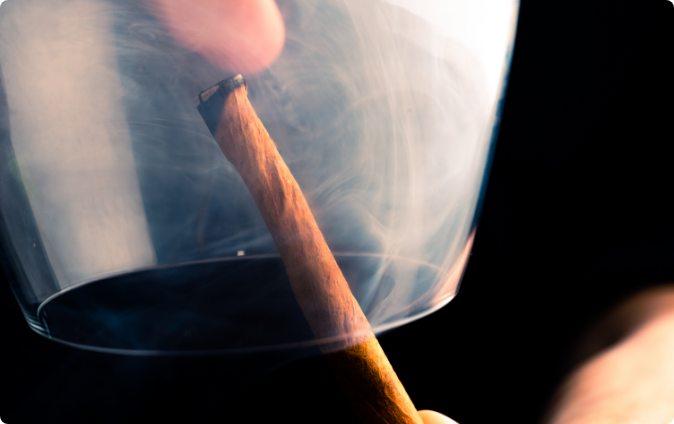 Smoke treating a whiskey glass